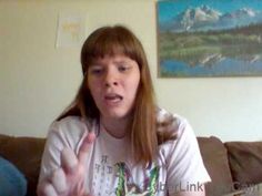 a woman sitting on top of a couch talking to someone