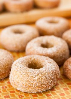 there are many sugar donuts on the table