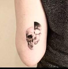 a woman with a skull tattoo on her arm