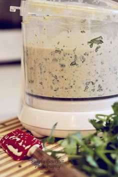 a food processor is filled with something green