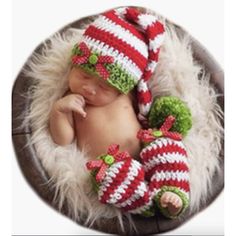 a newborn baby wearing a santa hat and matching booties