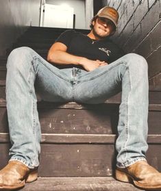 a man sitting on top of some stairs