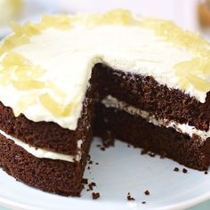 there is a chocolate cake with white frosting and lemons on the top slice