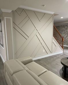 a living room with white leather couches in it