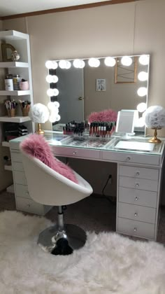 a white chair sitting in front of a desk with a mirror on top of it