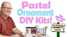 a man sitting at a table with some candy on it and a sign that says pastel ornament diy kits