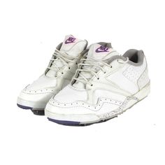 a pair of white sneakers with purple accents