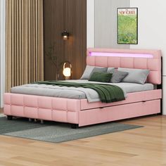 a pink bed sitting on top of a wooden floor