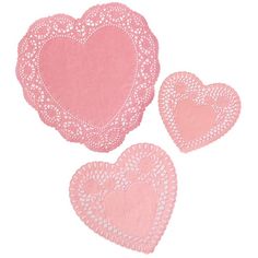 three pink heart shaped doily on a white background