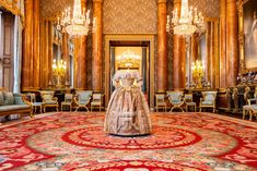 an elaborately decorated room with chandeliers and paintings on the walls in gold