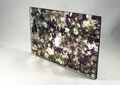 a glass plate with purple and white flowers on it