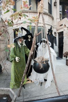 two people dressed as witches and one is holding a caulder