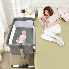 a woman sitting on a bed next to a baby crib