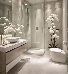 a modern bathroom with white flowers in vases