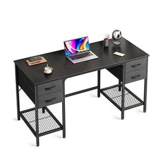 a computer desk with a laptop on it and other office supplies sitting on top of it