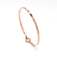 This stackable 14K rose gold filled bangle opens and closes with the hook and eye hinge enclosure system. A little pinch on both sides of the bangle opens and closes it. This gold cuff bracelet shares the understated, classic beauty of the other bangles in the open bangle collection. This beauty will be your everyday accessory for years to come.  Hand forged from 14k rose gold filled wire, it has been polished to a high shine. It  The width of the bangle is approx. 3mm. Features:  * 14k rose gold fill * Opens and closes for easy on and off * Size inclusive * Stackable * Approx. 3mm in width - Made to order  - Will ship out 3-5 business days from the date of purchase To measure your wrist, wrap measuring tape or a piece of string loosely around your wrist. If you are using string, put it up Bangle Collection, Cuff Bracelet Gold, Rose Gold Bangle, Wrist Wrap, Open Bangle, Gold Bracelet Cuff, Gold Cuffs, Hinged Bracelet, Bracelet Cuff