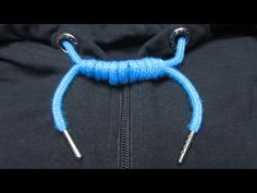 the zipper on a black hoodie has blue thread attached to it