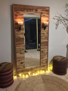 a large mirror sitting on top of a wooden floor