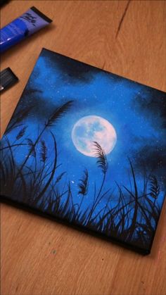 an acrylic painting of a full moon in the night sky with grass and reeds