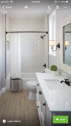 a bathroom with white fixtures and wood flooring