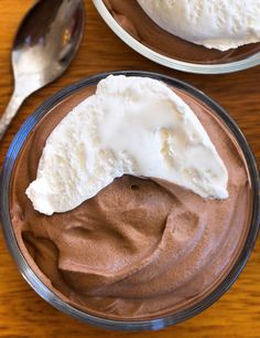 two bowls filled with chocolate pudding and whipped cream