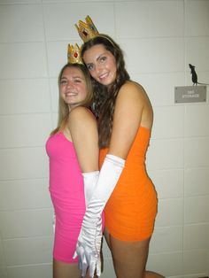 two women in orange and pink dresses pose for the camera with their arms around each other