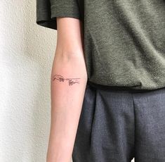 a person with a small tattoo on their arm