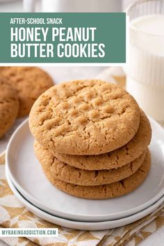 a stack of peanut butter cookies sitting on top of a white plate next to a glass of milk