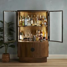 a wooden cabinet filled with lots of liquor bottles