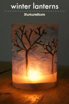 a paper lantern with trees on it and the words winter lanterns written in white ink