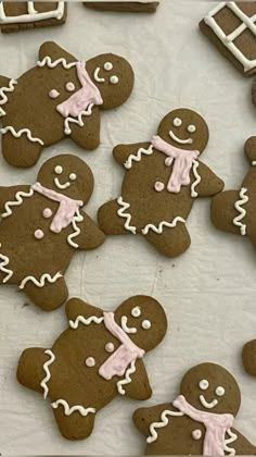 several gingerbread cookies with icing on a table