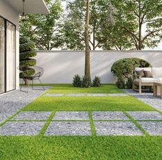 an outdoor patio with grass and stepping stones