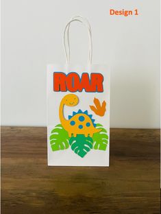 a paper bag with an image of a dinosaur and the word roar printed on it