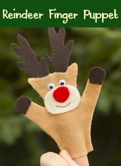 a hand holding up a reindeer finger puppet with the words reindeer finger puppet on it