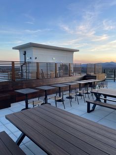 tables and benches on the roof of a building