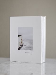 a white book with an image of the ocean on it