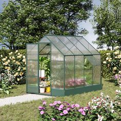 a small green house surrounded by flowers and trees