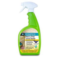 a bottle of stone tech heavy duty granite sealer on a white background with a green spray