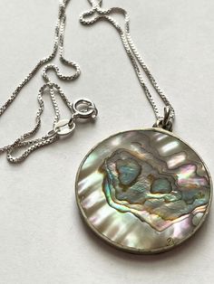 This is a lovely vintage sterling silver Mexico Abalone pendant necklace.  The pendant measures one and 1/4 inches. The chain measures 18 inches. The necklace weighs 8.5 g. The chain is hallmarked 925 Italy The pendent is a double strike mark of Hecho en México 925 This item is an excellent preowned vintage condition with normal wear for the age Vintage Silver Necklace With Round Pendant, Vintage Round Pendant Necklace With Polished Finish, Abalone Necklace, Sterling Silber, Vintage Sterling Silver, Pendant Necklaces, Necklace Etsy, Jewelry Necklace Pendant, Jewelry Necklaces