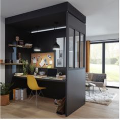 a home office with black walls and wooden floors