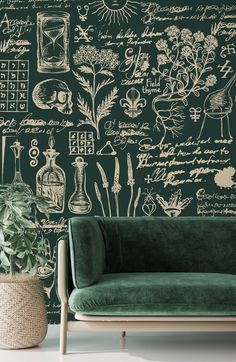 a green couch sitting in front of a wall with writing on it and plants growing out of bottles