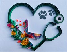 a stethoscope laying on top of a heart shaped card with flowers and a dog's paw