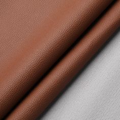 two different colors of leather on top of each other, one is white and the other is brown