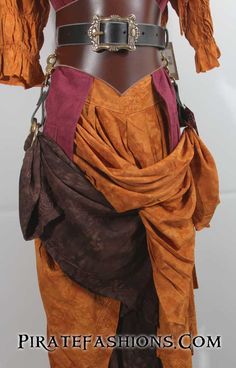 a mannequin dressed in an orange and brown outfit with chains around the waist