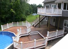 an above ground swimming pool with deck and stairs