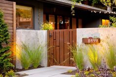 the front entrance to a home with plants and flowers