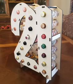 the letter k is made out of beer cans and has multiple screws on it