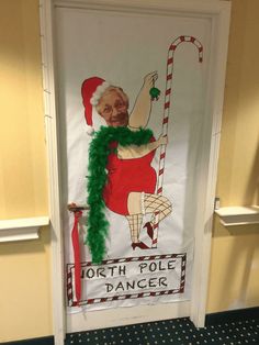 a door decorated with an old fashioned christmas sign and santa clause holding a candy cane