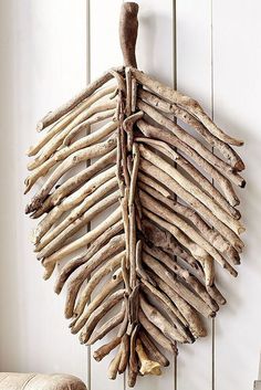 driftwood art hanging on the wall next to a chair