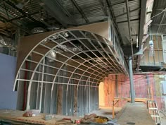 the inside of a building under construction with metal framing and walls being built around it